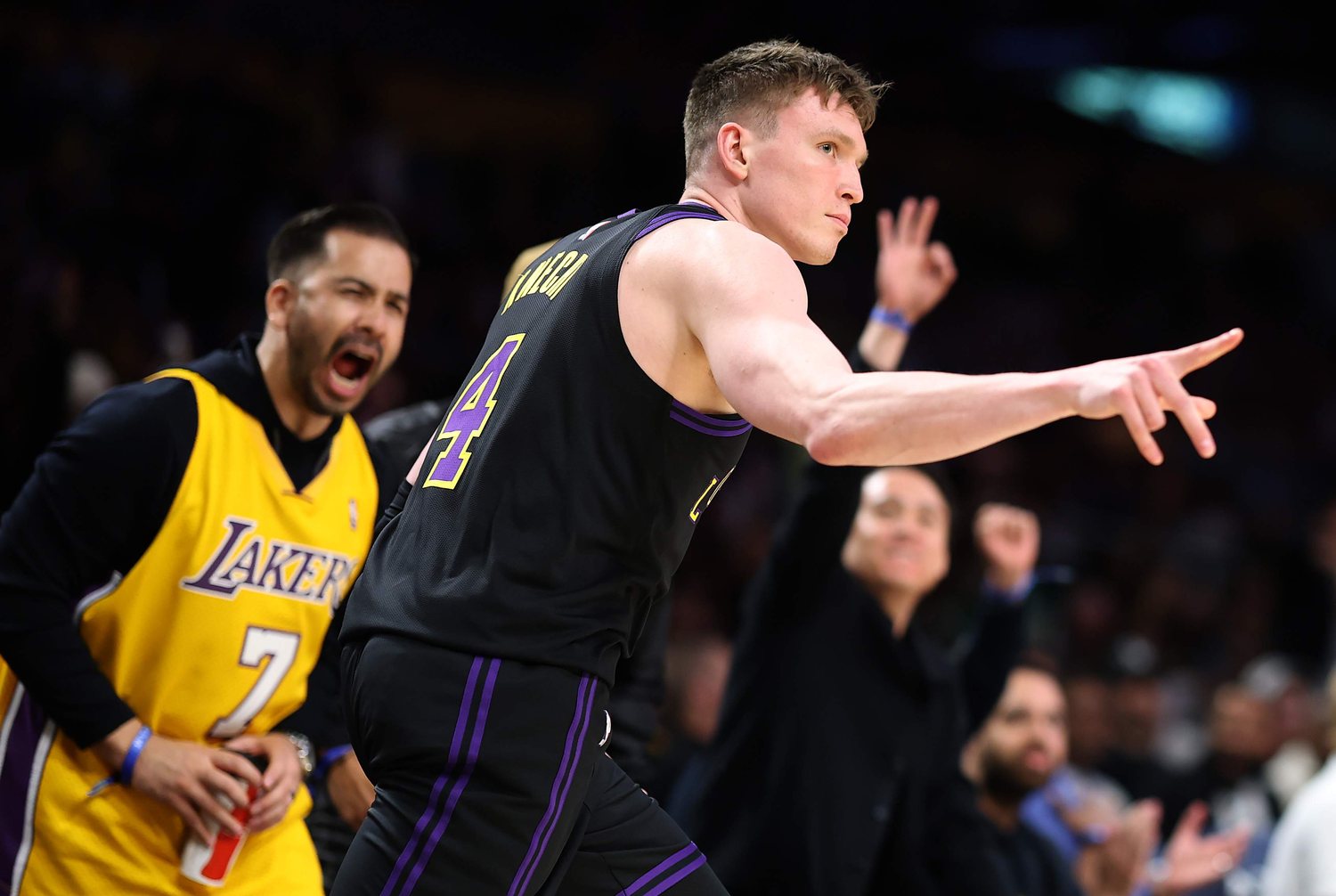 Dalton Knecht points across the court in a dark Lakers No. 4 jersey.