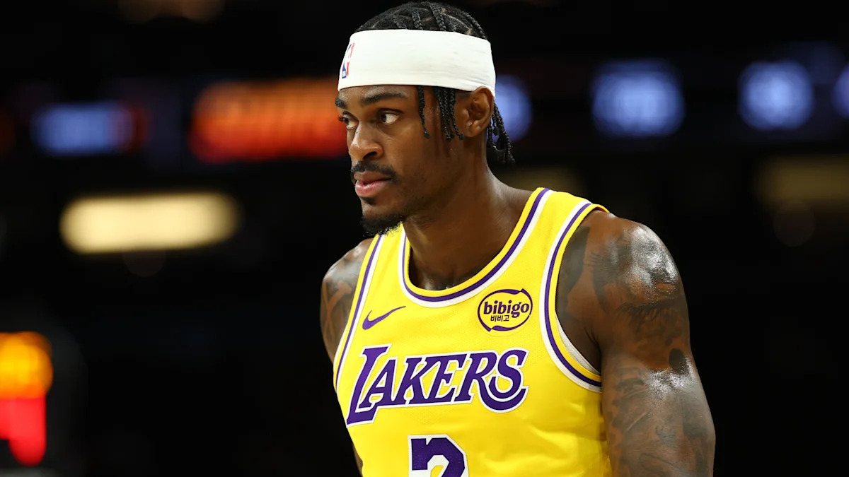 Jarred Vanderbilt looks across the court in a gold Lakers jersey.