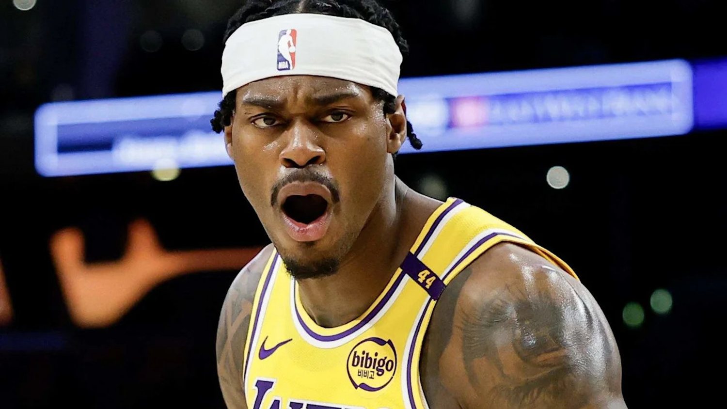 Jarred Vanderbilt reacts in a gold Lakers jersey and white headband.