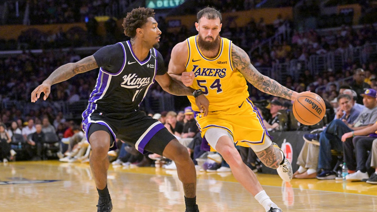 Sandro Mamukelashvili dribbles in a gold No. 54 Lakers uniform against Sacramento.